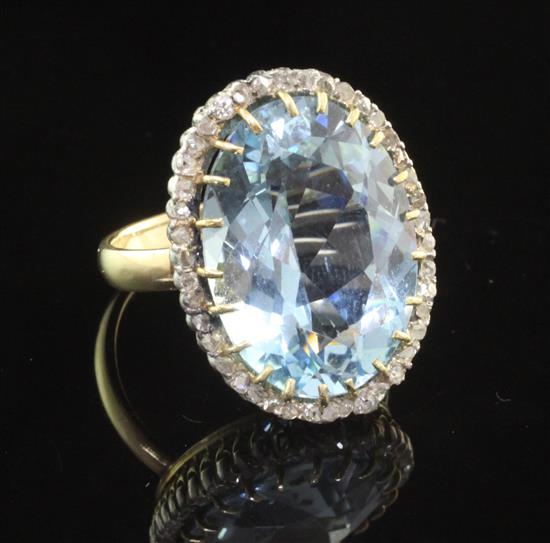 A gold, aquamarine and diamond set dress ring, size I.